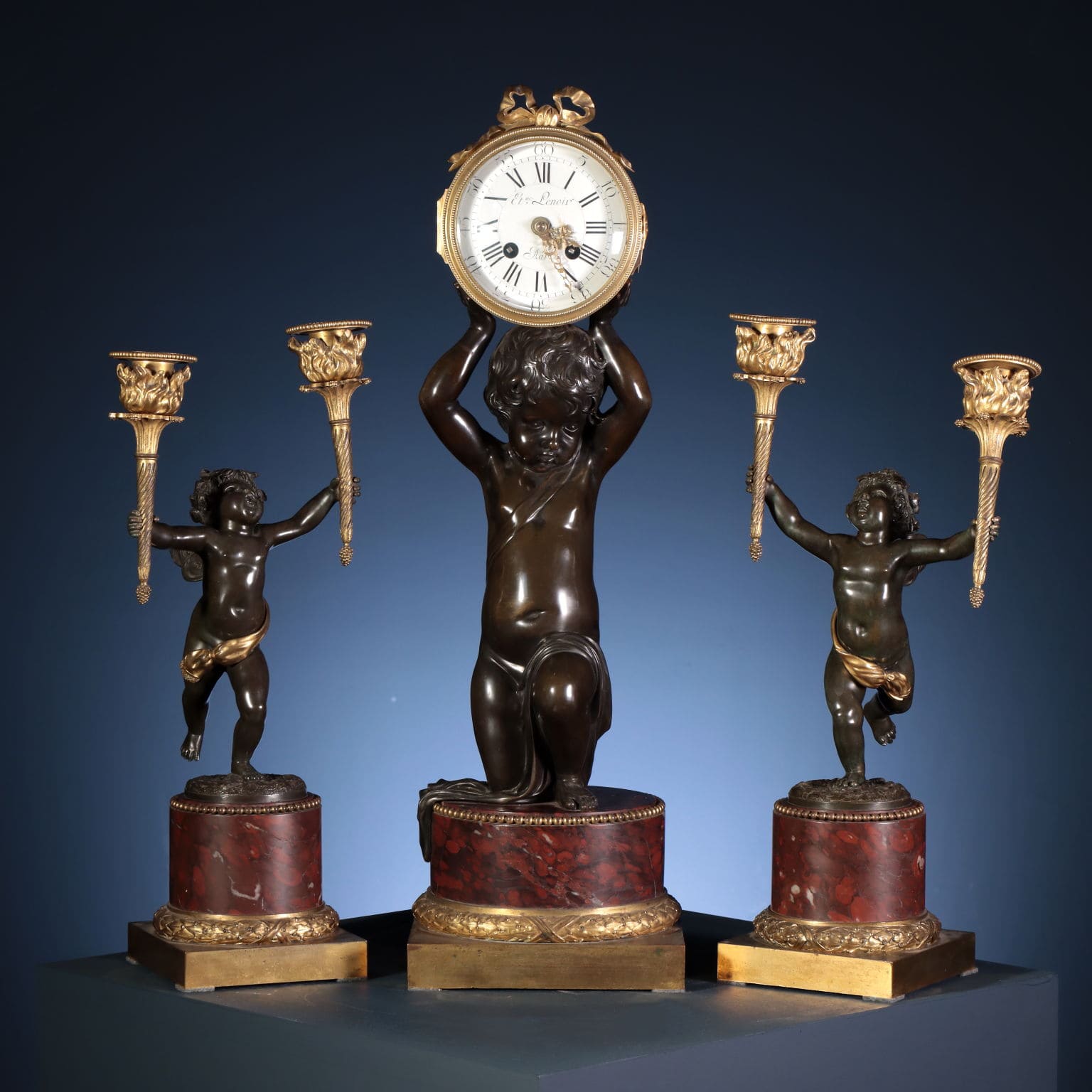 Triptych with clock and pair of candelabra