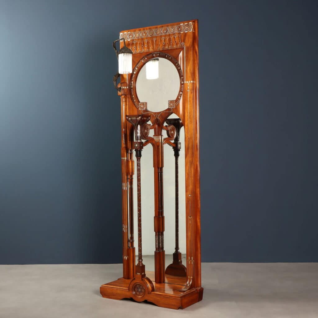 Wall mirror featuring pointed arches, circular mirror and integrated plant stand.
