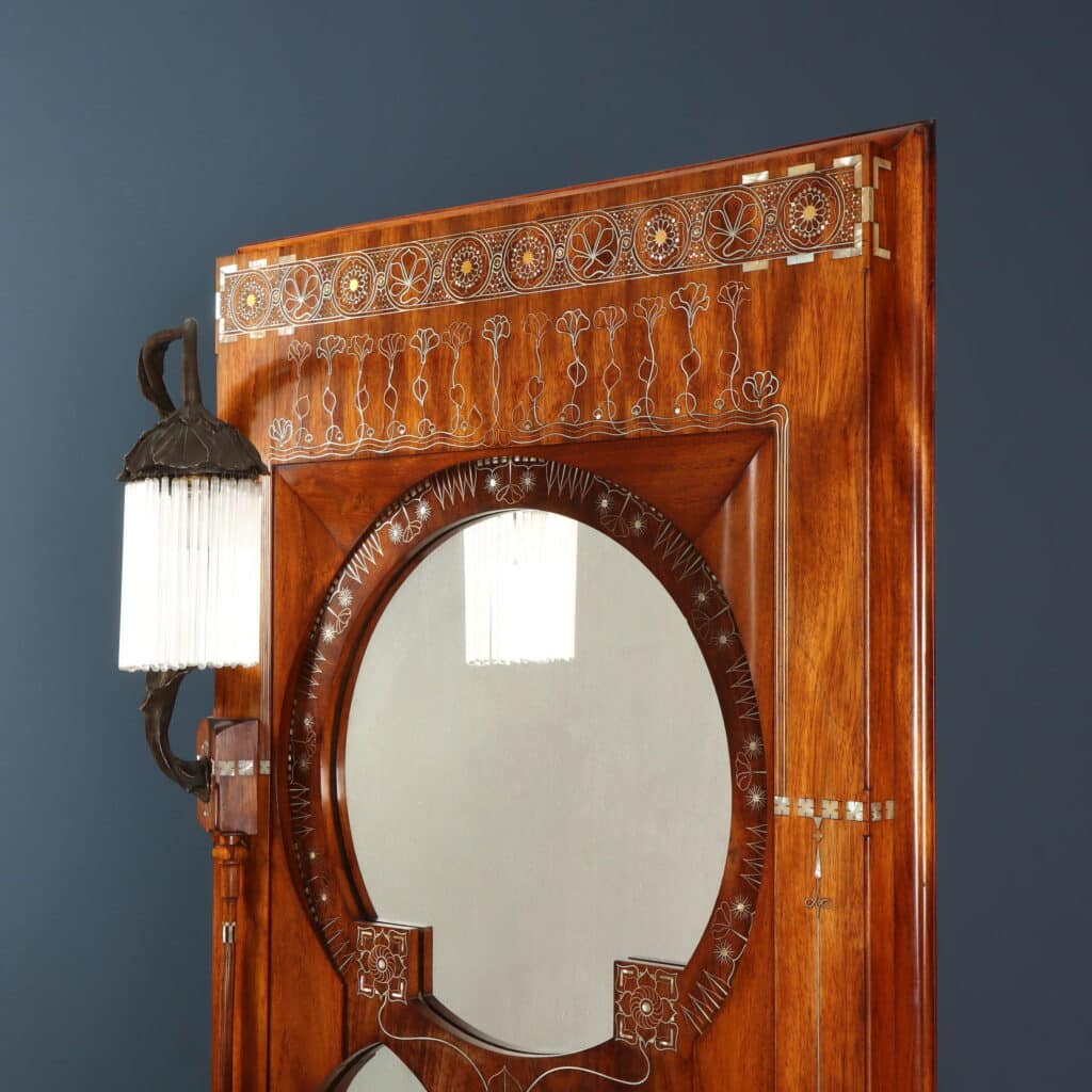 Wall mirror featuring pointed arches, circular mirror and integrated plant stand.