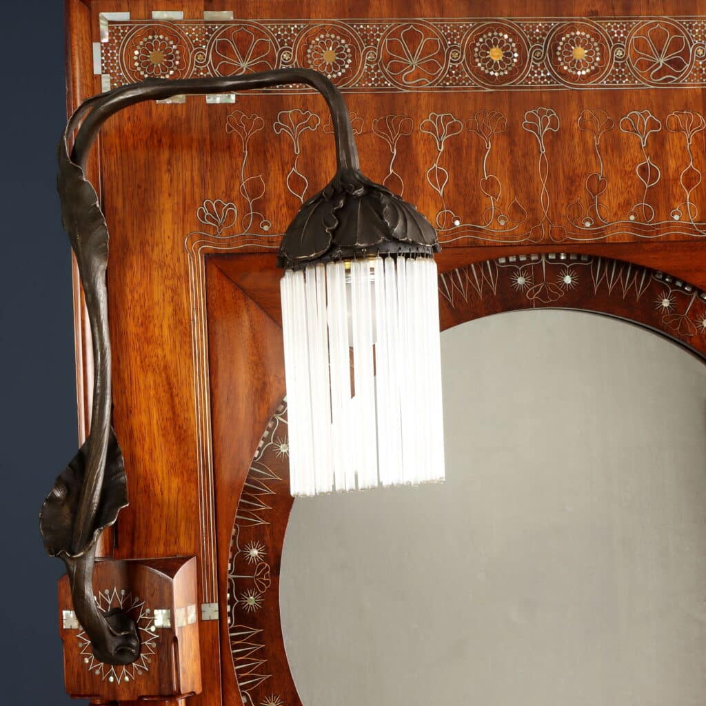 Wall mirror featuring pointed arches, circular mirror and integrated plant stand.