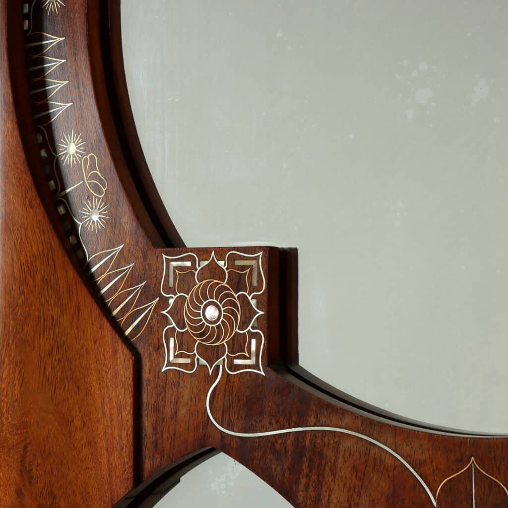Detail of the wall mirror with Oriental-inspired decorative motifs and fine marquetry.
