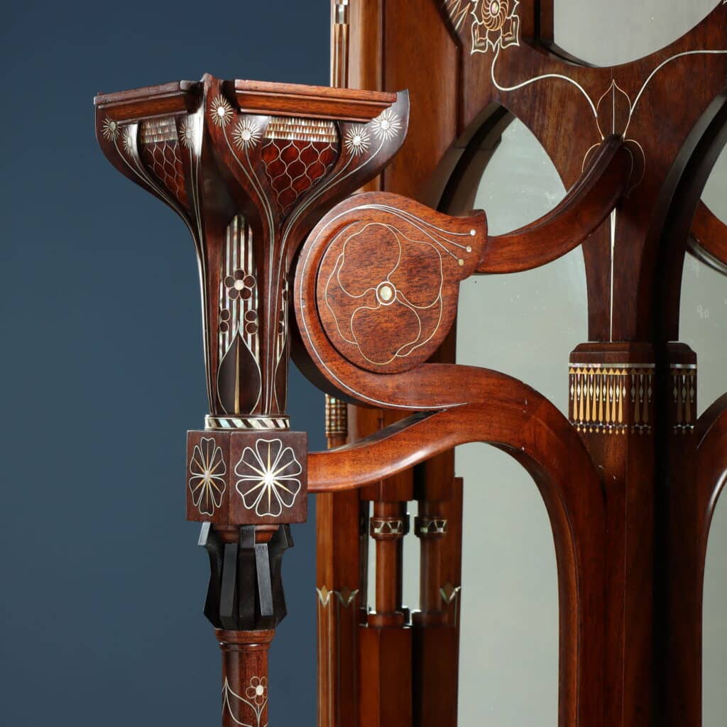 Detail of the wall mirror with Oriental-inspired decorative motifs and fine marquetry.