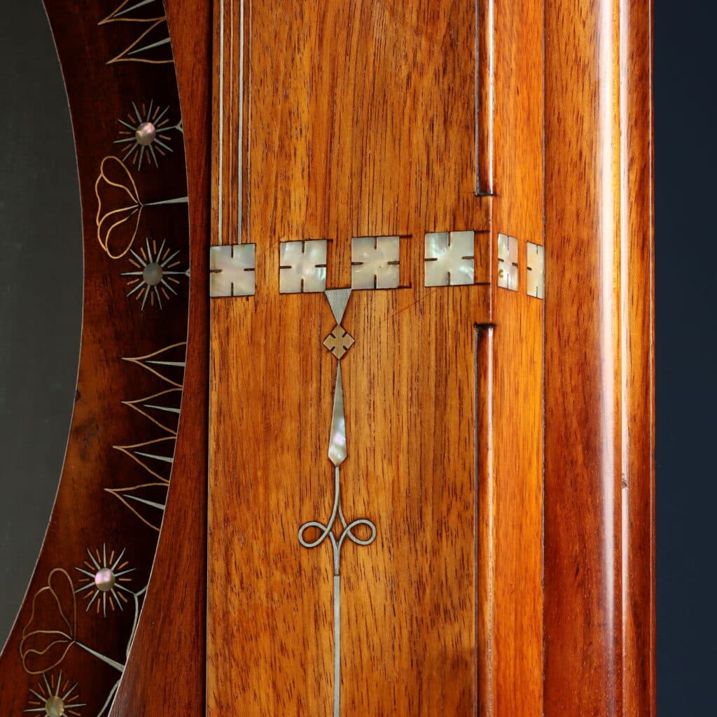 Detail of the wall mirror with Oriental-inspired decorative motifs and fine marquetry.
