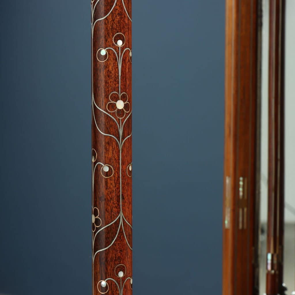 Detail of the wall mirror with Oriental-inspired decorative motifs and fine marquetry.