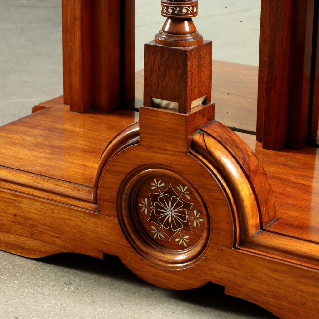 Detail of the wall mirror with Oriental-inspired decorative motifs and fine marquetry.
