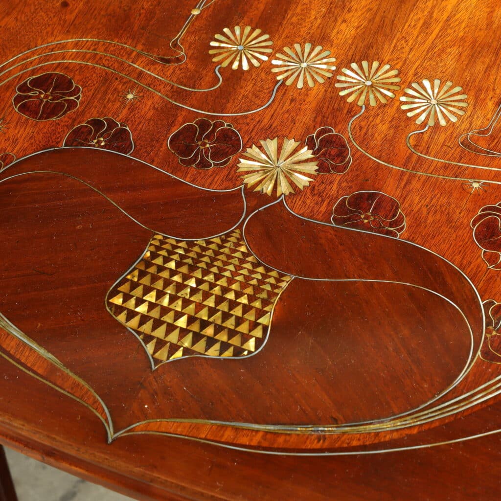 Mahogany writing desk enriched with brass stringing and floral marquetry.