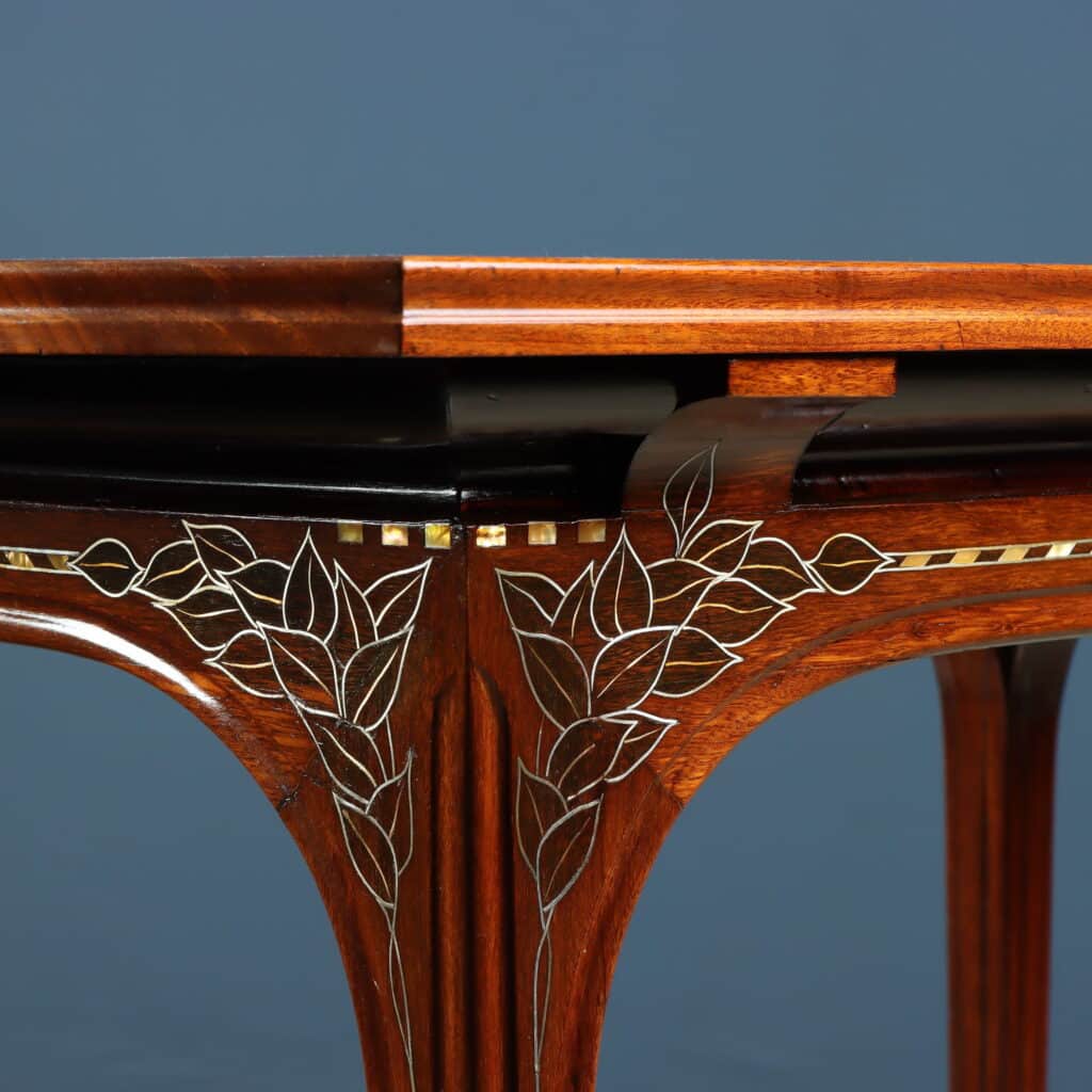 Mahogany writing desk enriched with brass stringing and floral marquetry.