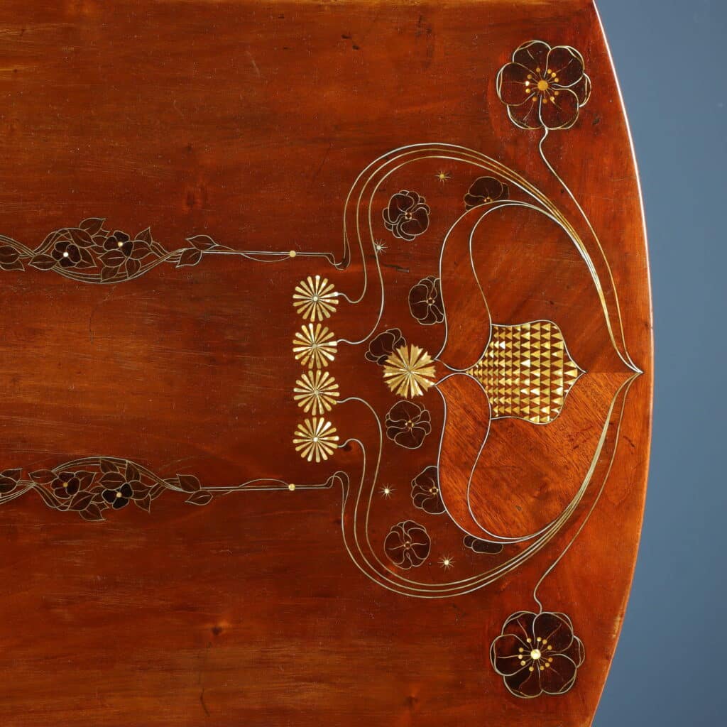 Mahogany writing desk enriched with brass stringing and floral marquetry.