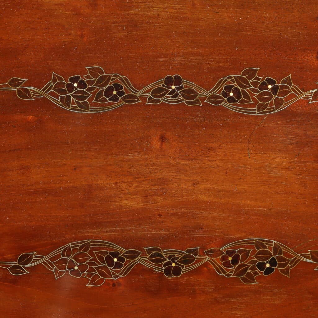 Mahogany writing desk enriched with brass stringing and floral marquetry.