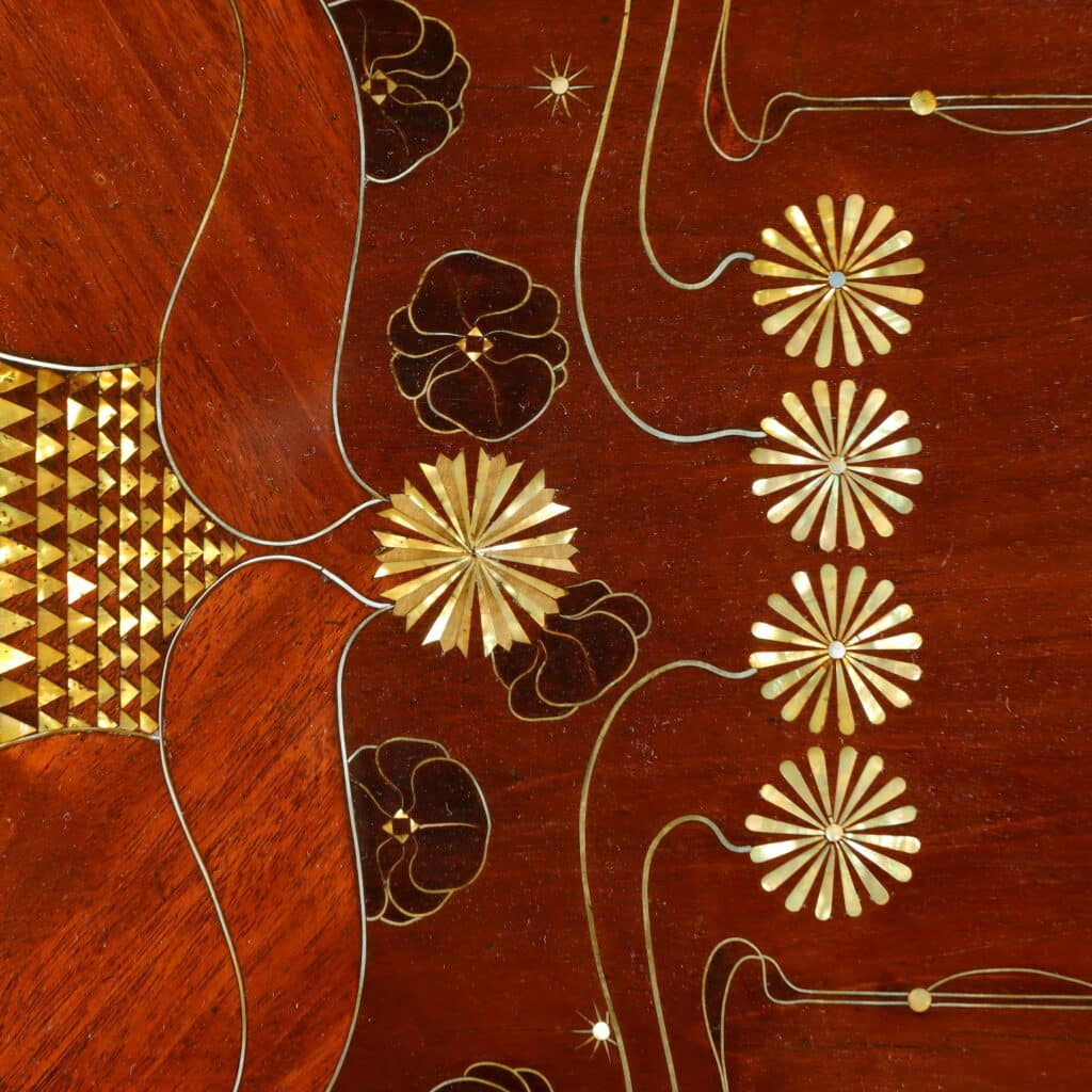 Mahogany writing desk enriched with brass stringing and floral marquetry.