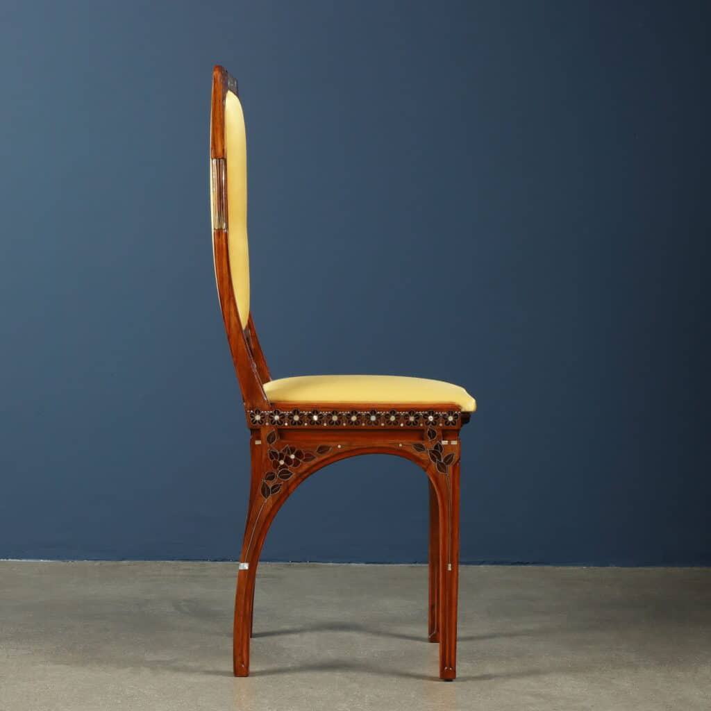 Original chair upholstered in yellow silk with gracefully arched legs.
