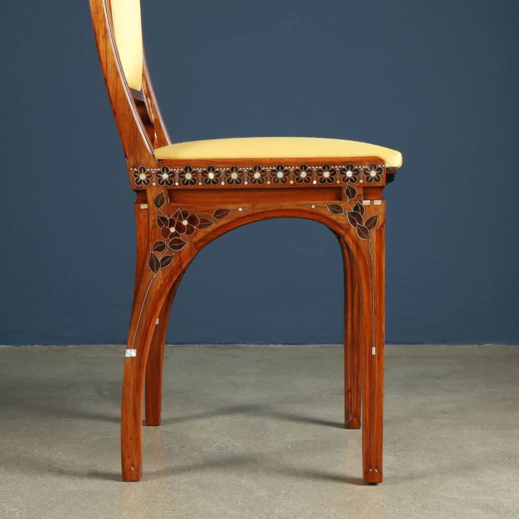 Original chair upholstered in yellow silk with gracefully arched legs.