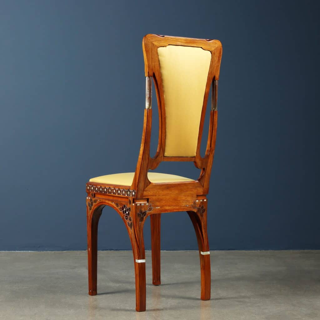 Original chair upholstered in yellow silk with gracefully arched legs.