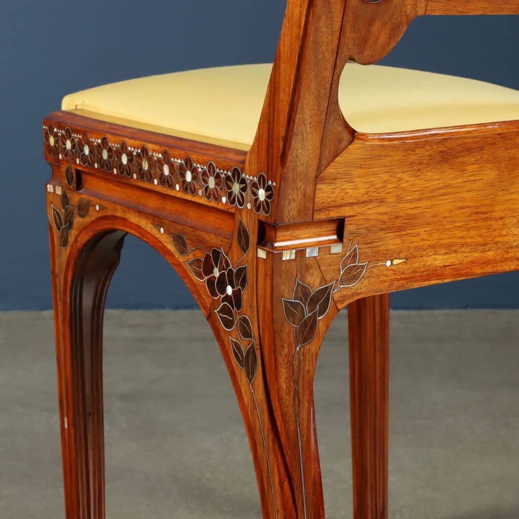 Original chair upholstered in yellow silk with gracefully arched legs.